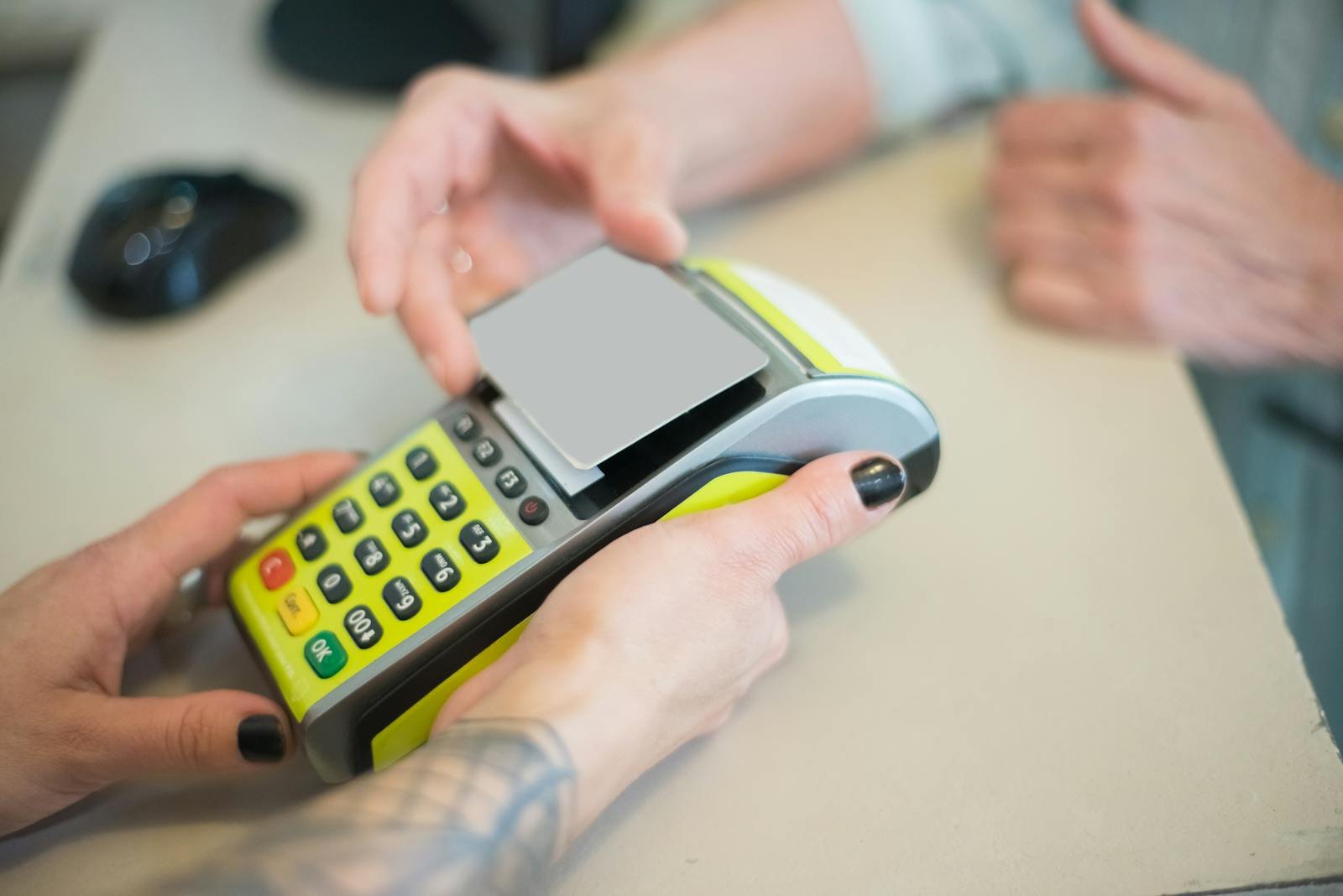 Hands engaging in a secure card transaction with a payment terminal, capturing the essence of modern business transactions.